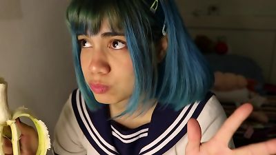 Deep throat: schoolgirl puts a whole banana in her mouth.