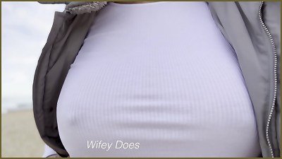 stripped to the waist wife walks on the public beach